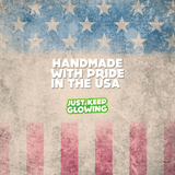 Image showcasing Just Keep Glowing's commitment to US manufacturing and handcrafted quality. Features a faded American flag design and the text "Handmade with Pride in the USA," emphasizing their dedication to quality craftsmanship and patriotic values.