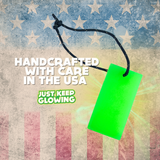 Forever Glow Bar: Handcrafted, reusable, battery-free light made in the USA. American flag background. Text: Handcrafted with Care in the USA. Just Keep Glowing.