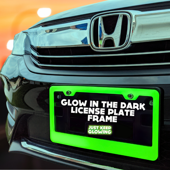 Green glow in the dark license plate frame illuminating the front of a black car, enhancing visibility and adding a unique style. Just Keep Glowing.