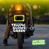 Yellow glow in the dark motorcycle license plate frame emitting a green glow, enhancing visibility and adding a unique style to a motorcycle at night. Just Keep Glowing.